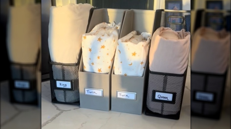 Various sized sheet sets put in file holders with size labels on the front