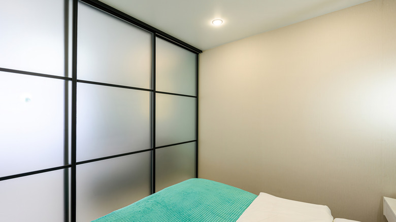 frosted sliding door by bed