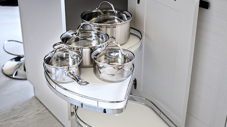 A lazy susan in a kitchen corner cabinet.