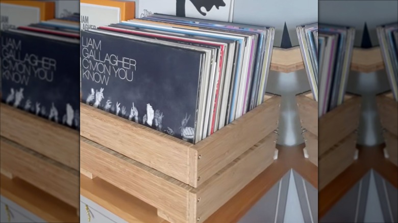 Vinyl records are stored in a wooden crate