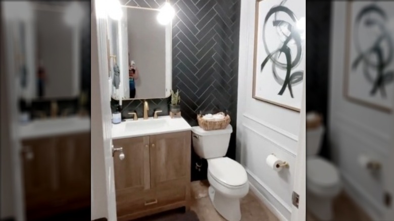 Bathroom with black tile accent wall