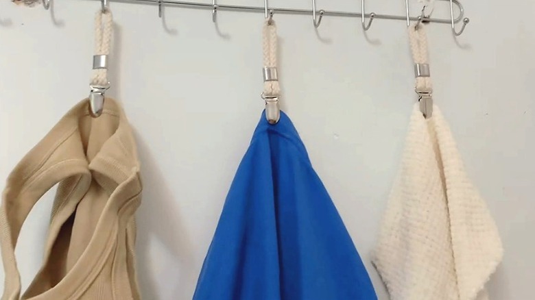Woledy Hanging Tea Towel Clip holding hand towels on a metal hook