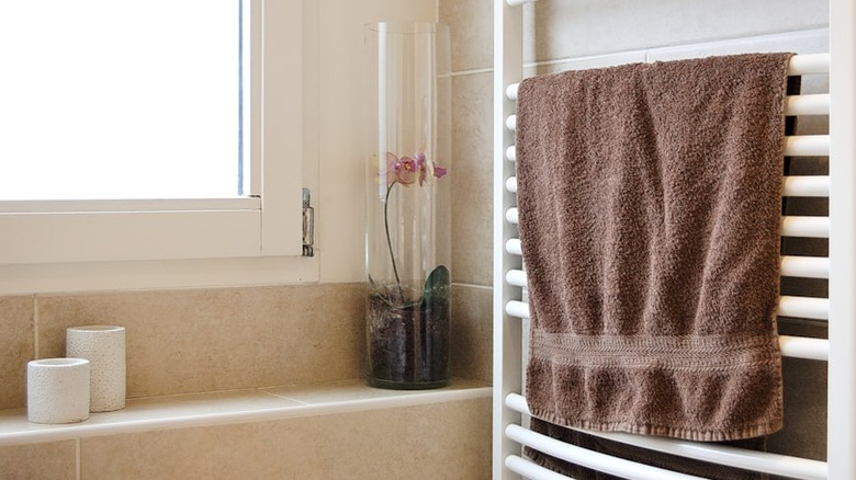 bathroom towel on white metal rack