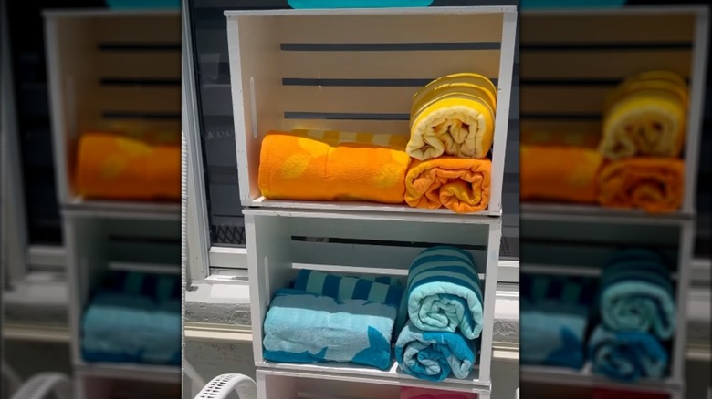 Stack of wooden crates holding rolled towels