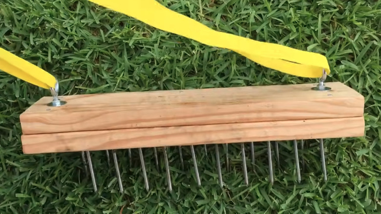 DIY lawn aerator tool made from wood blocks and nails