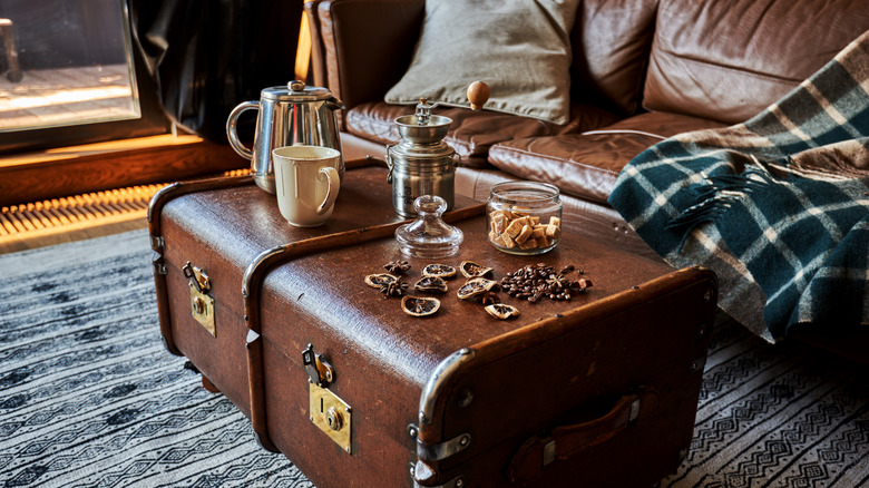 An old trunk being used as a living room coffee table