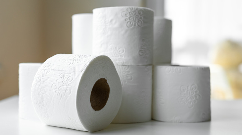 Stack of toilet paper on white counter