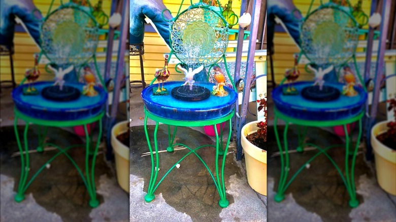 Bird bath on old iron chair