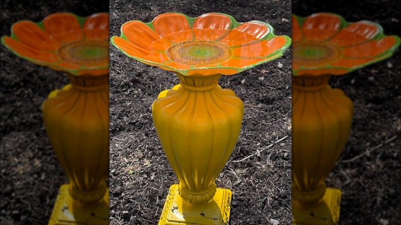 Yellow lamp transformed into birdbath