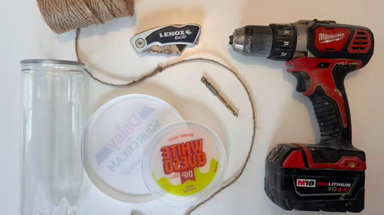 Tennis ball container, drill, string, plastic lids for making bird feeder