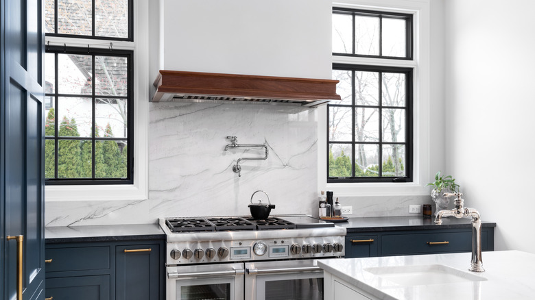 White and blue kitchen with large windows