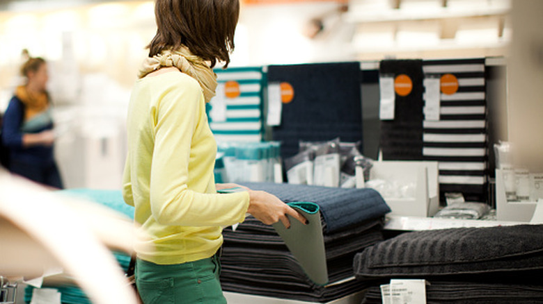 A person shopping for doormats
