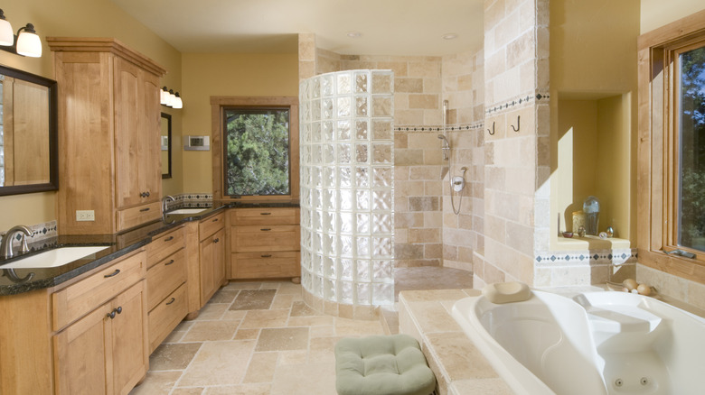 Rustic wood and stone bathroom with a glass block shower wall