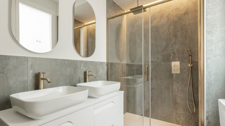 White bathroom with sliding glass shower doors