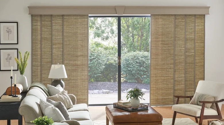 Bali blinds wood texture sliding panels over glass door in living room