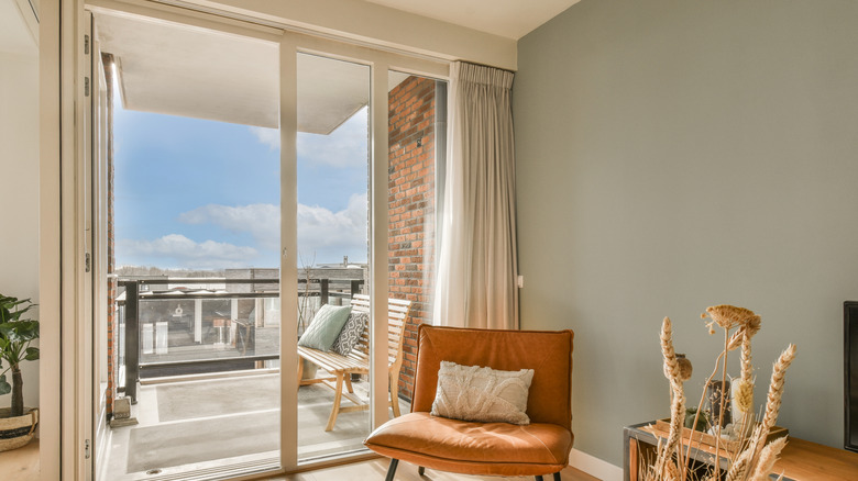 Sliding door onto a balcony with curtains
