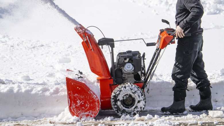 Man removing snow with snow blower
