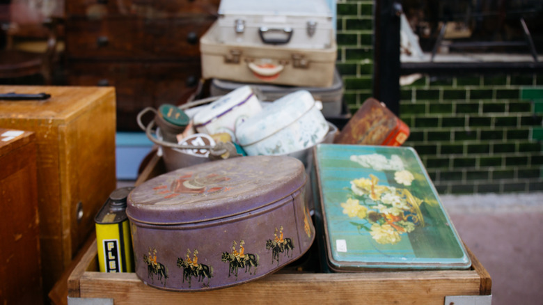 A selection of old tins in a thrift store