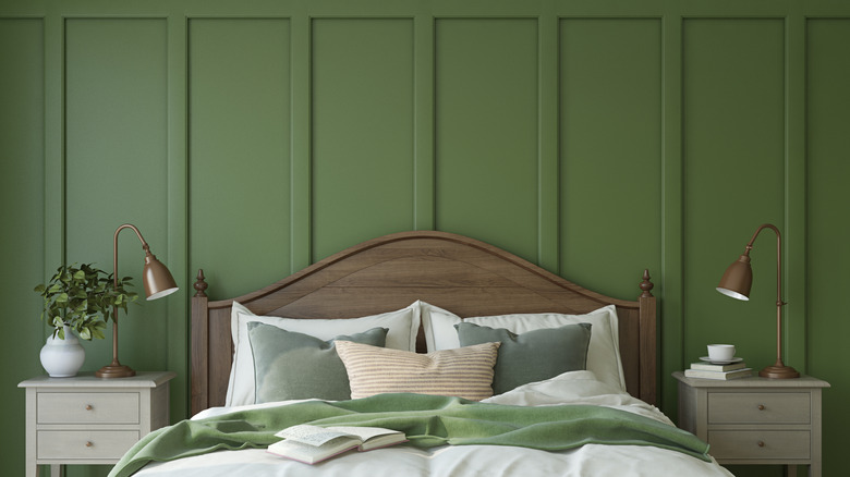 bedroom with a medium green board and batten accent wall