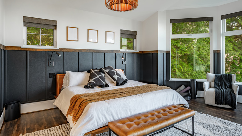 bedroom with modern black board and batton accent wall wrapping the room