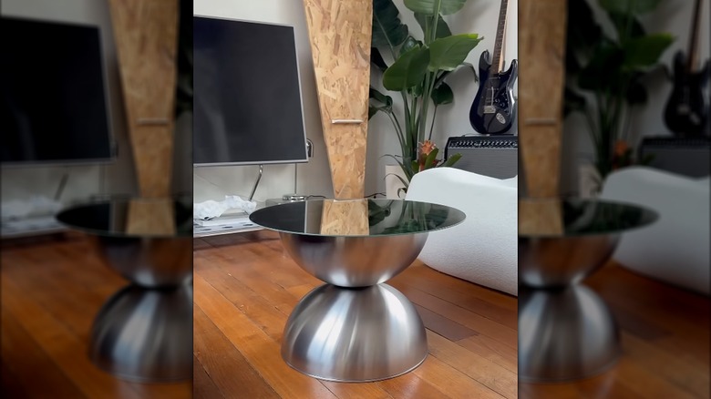 Contemporary metal living room coffee table made from IKEA metal bowls and round mirror in a living room