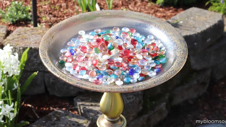 A DIY birdbath made with a thrifted lamp