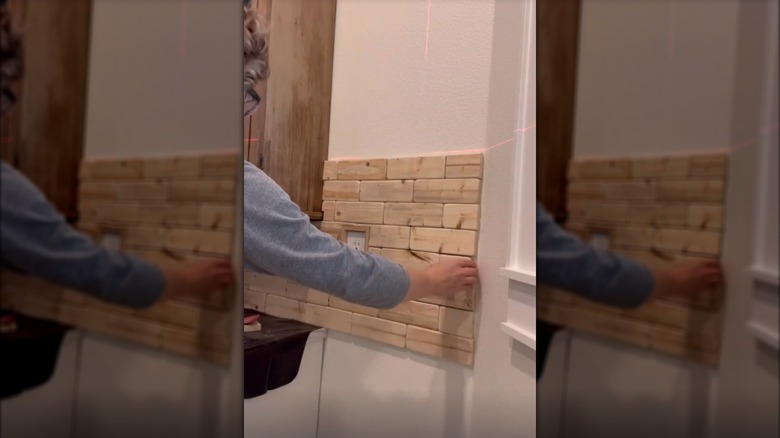 Adding the last "brick" to a wood brick laundry room wall