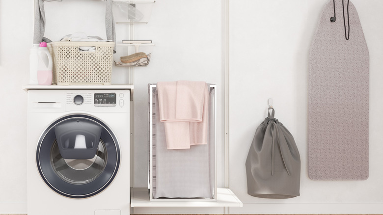A laundry room with plain white walls