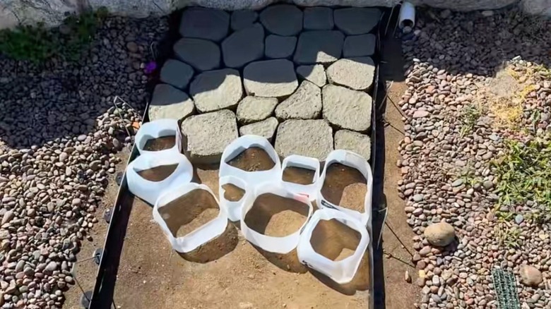creating a faux-cobblestone garden pathway using milk jug molds for each stone