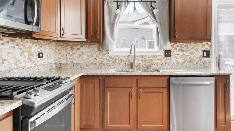 A kitchen with a dated backsplash