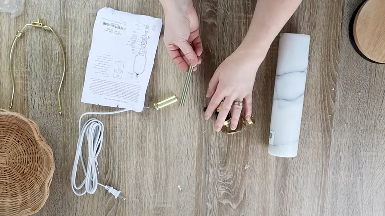 person using a marble rolling pin and wiring for a DIY