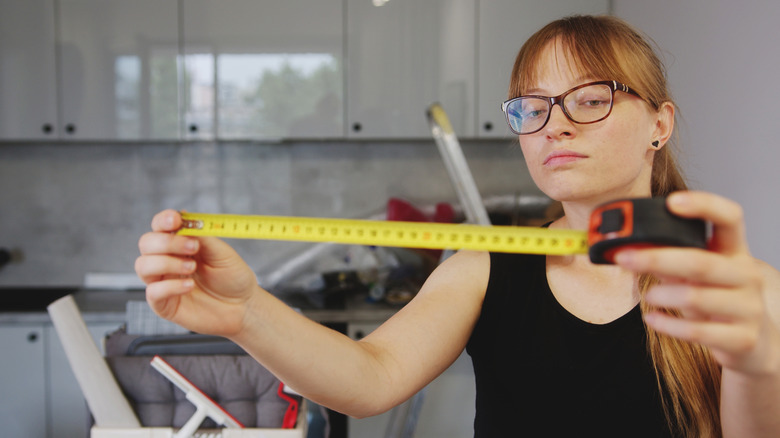 Woman measuring before she starts a project