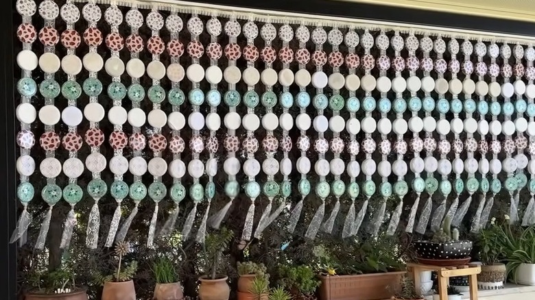 DIY privacy screen made from jar lids