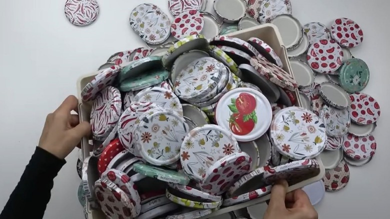 Woman holding big box of jar lids