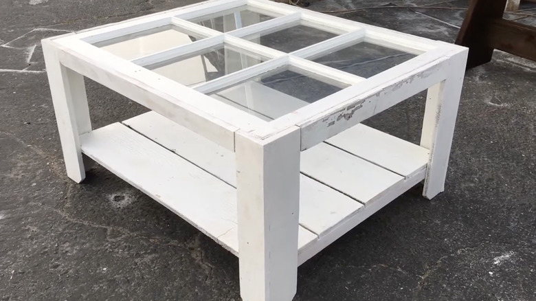 A coffee table with a distressed window pane tabletop.