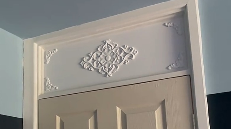 You can make this ornate transom window cover in just a few steps.