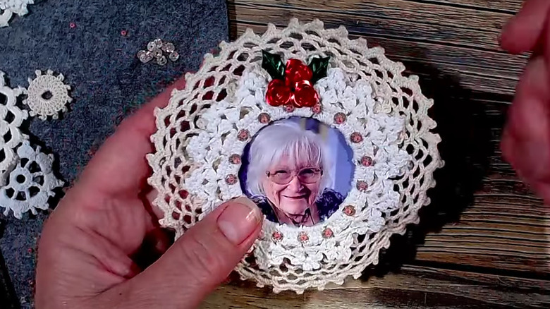 a photo wreath ornament made from a repurposed doily
