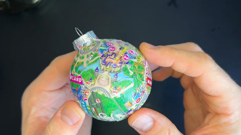 a round ornament decoupaged with a map