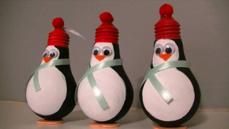 lightbulbs upcycled into penguin holiday ornaments