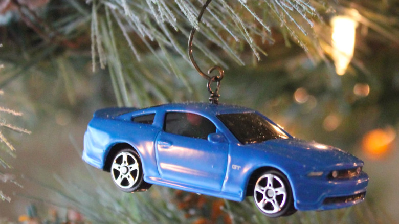 a Christmas tree ornament made from a small toy car