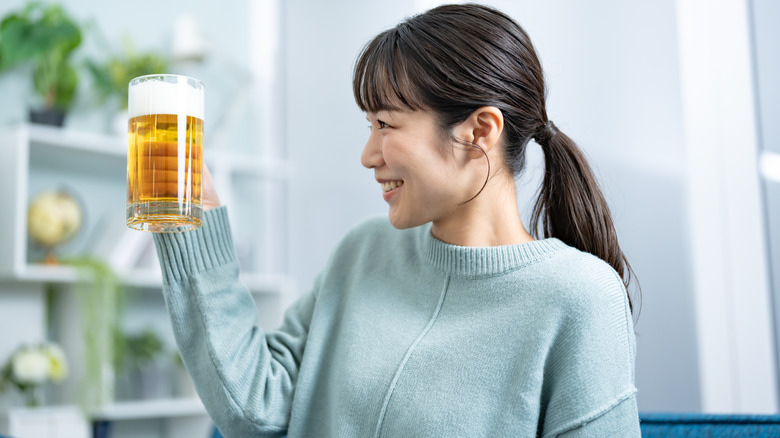 Japanese woman holding a cup of beer