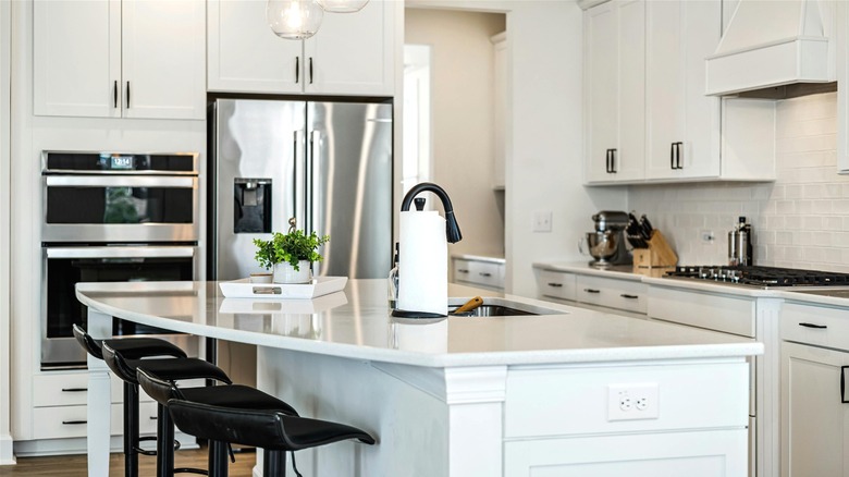 Family home kitchen with white cupboards and black accents