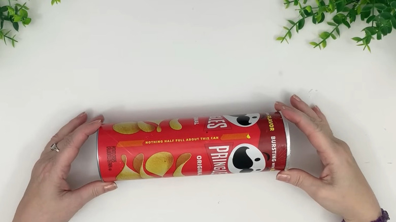 Creator working with a Pringles can on a white work surface
