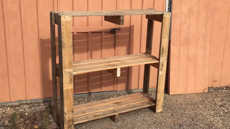 A small shelf made from wood palettes