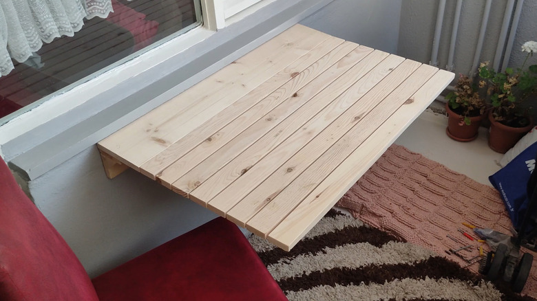 A foldaway desk or table made of pallet wood