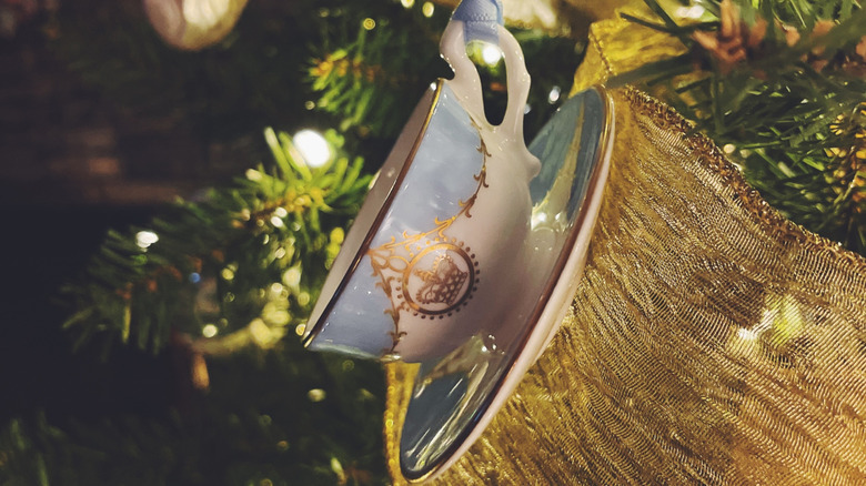 a teacup and saucer hangs from a Christmas tree