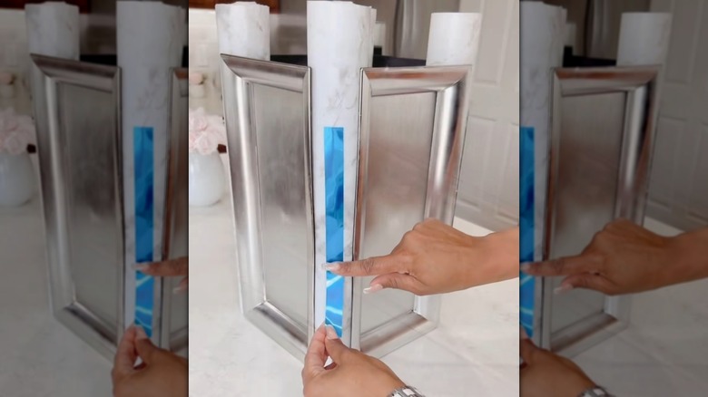 DIYer making side table out of pool noodles and trays