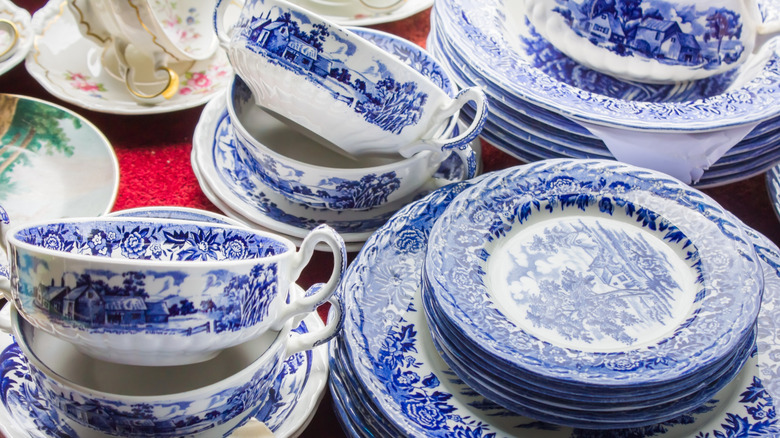A blue and white vintage tea set sits stacked on a table