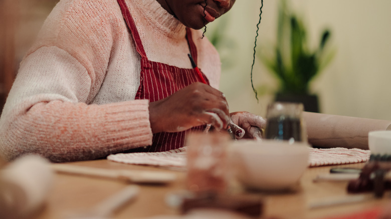 Woman happily crafting at table