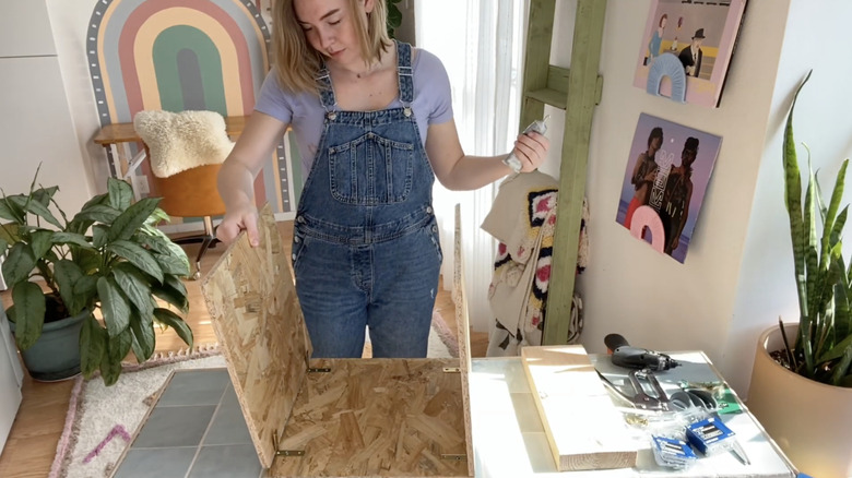 person building wooden bench frame